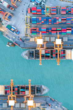 aerial view of shipping containers and cranes