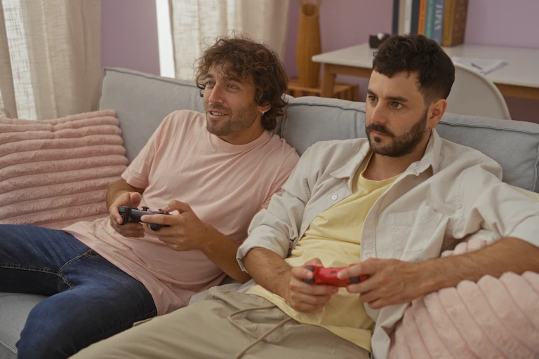 Two men play a video game.