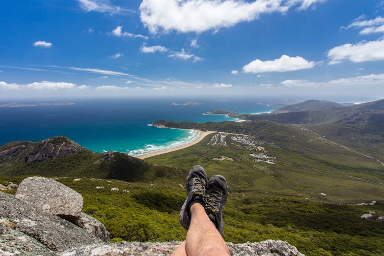 Hiker's shoes overlooking the view from the summit of Mt Oberon (Wilsons Promontory National Park, Victoria, Australia)