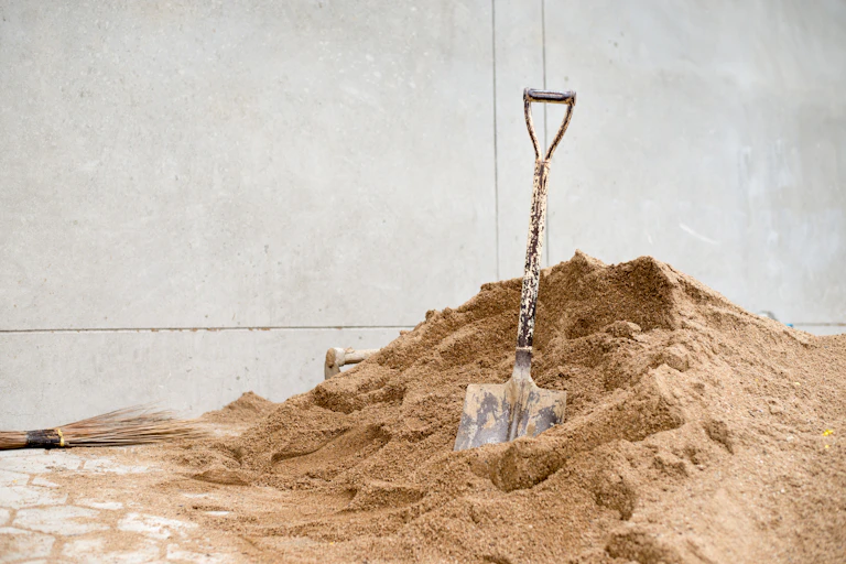 pile of sand and shovel.