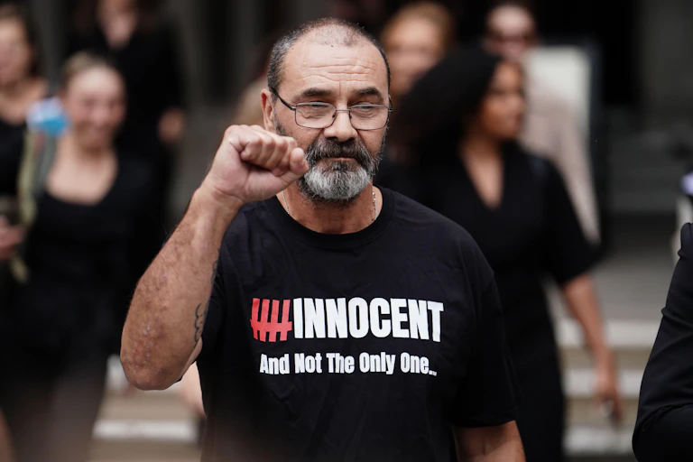 Man wearing 'innocent' t-shirt raises fist after being cleared of a crime
