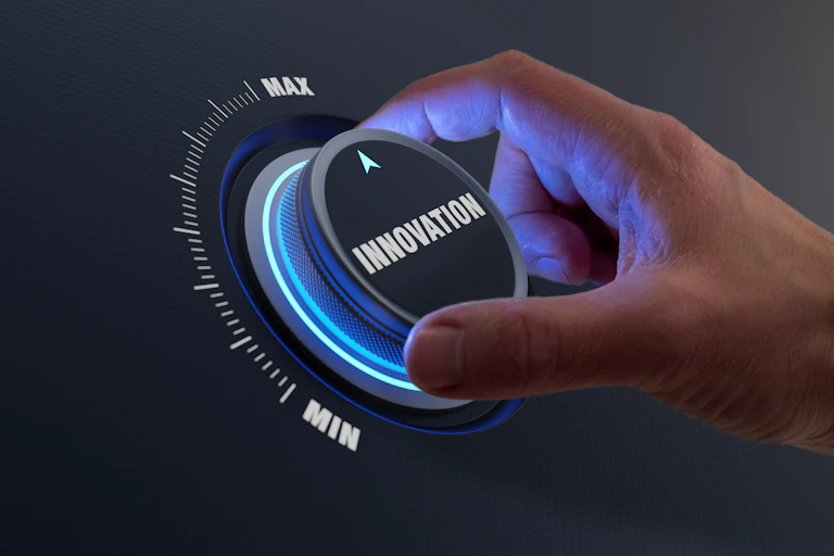 hand turning a dial labeled innovation