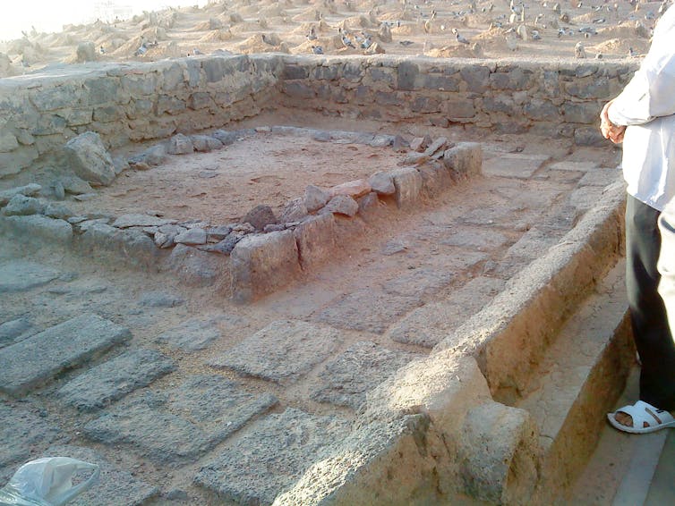Gravestones in sand.