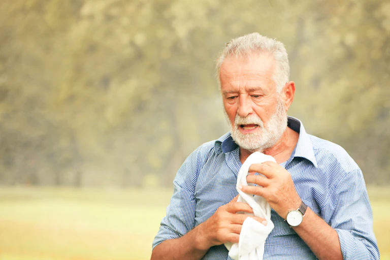 older man sweating in heat.