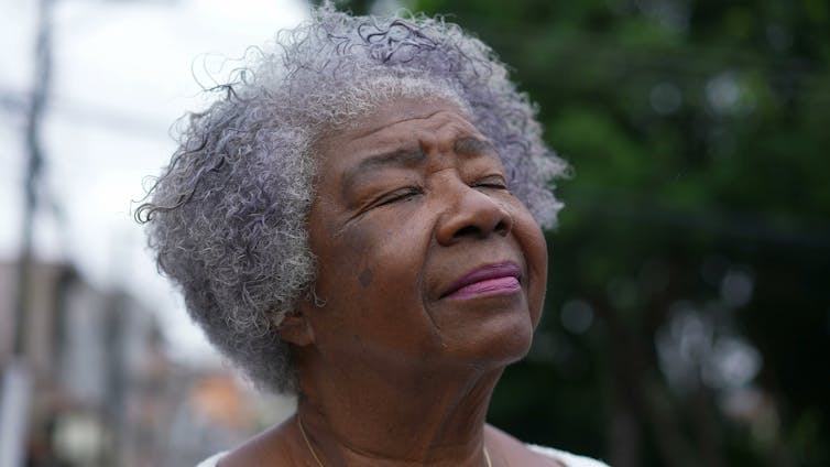 older african-american woman, pensive expression.