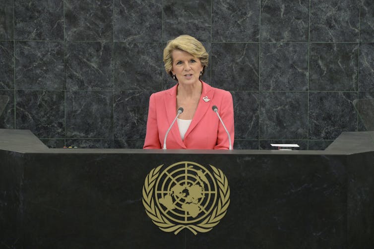 Julie Bishop stands on a podium addressing the United Nations General Assembly.