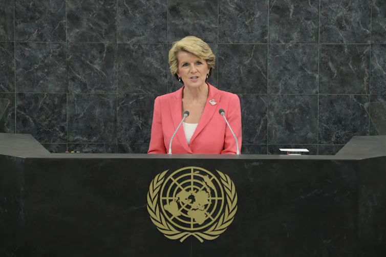 Julie Bishop stands on a podium addressing the United Nations General Assembly.