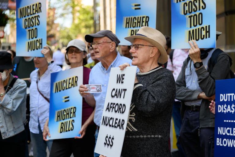 protesters hold anti-nuclear signs