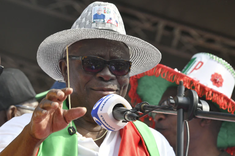A man standing behind a microphone