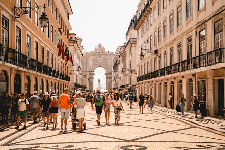 I feel you reinforce dwelling in town: vacationer ethics 1 People walking on a sunny pedestrian street.