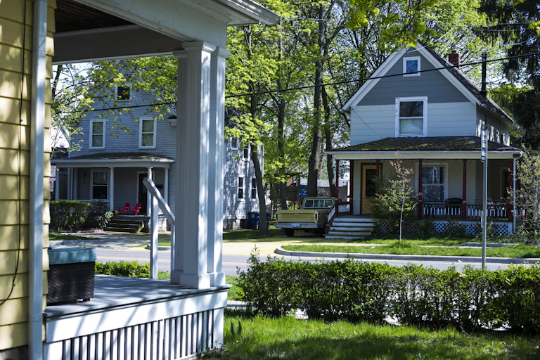 A power line sags between older homes on a street in Ann Arbor.