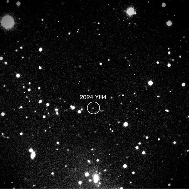 white dots scattered on a black background — one is circled and labelled 2024 YR4