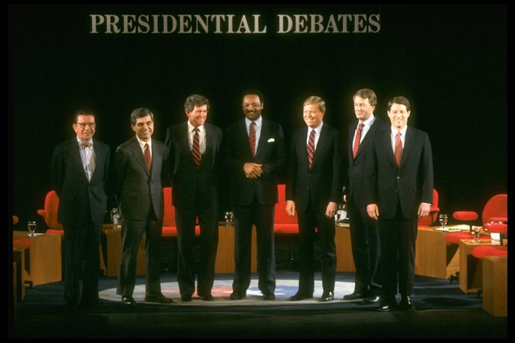 Men in suits stand on the debate stage; Jackson is the only Black candidate