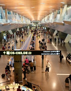 Passengers walking inside Doha International Airport