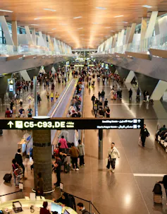 Passengers walking inside Doha International Airport