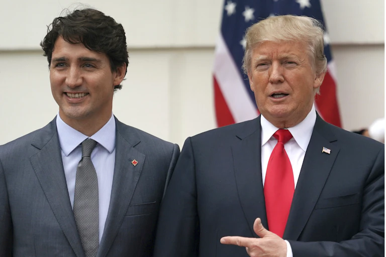 Two men in suits stand next to each other.