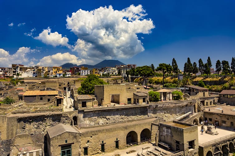 Photo of an ancient town with a mountain in the distance.