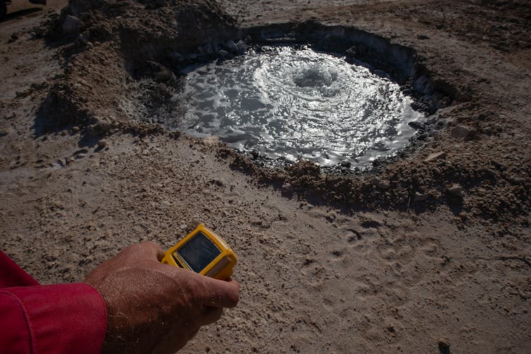 A gas reading being taken from a bubbling spring near Lake Boehmer