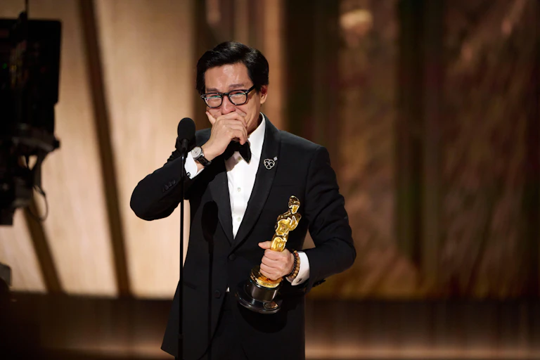 Ke Huy Quan on stage with his Oscar