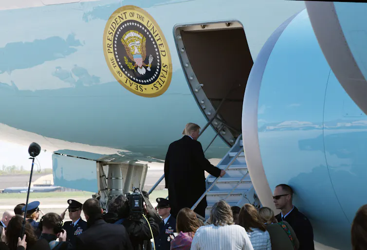 Donald Trump boards Air Force One watched by the White House press pool