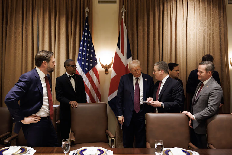 Donald Trump and Keir Starmer surrounded by their teams.