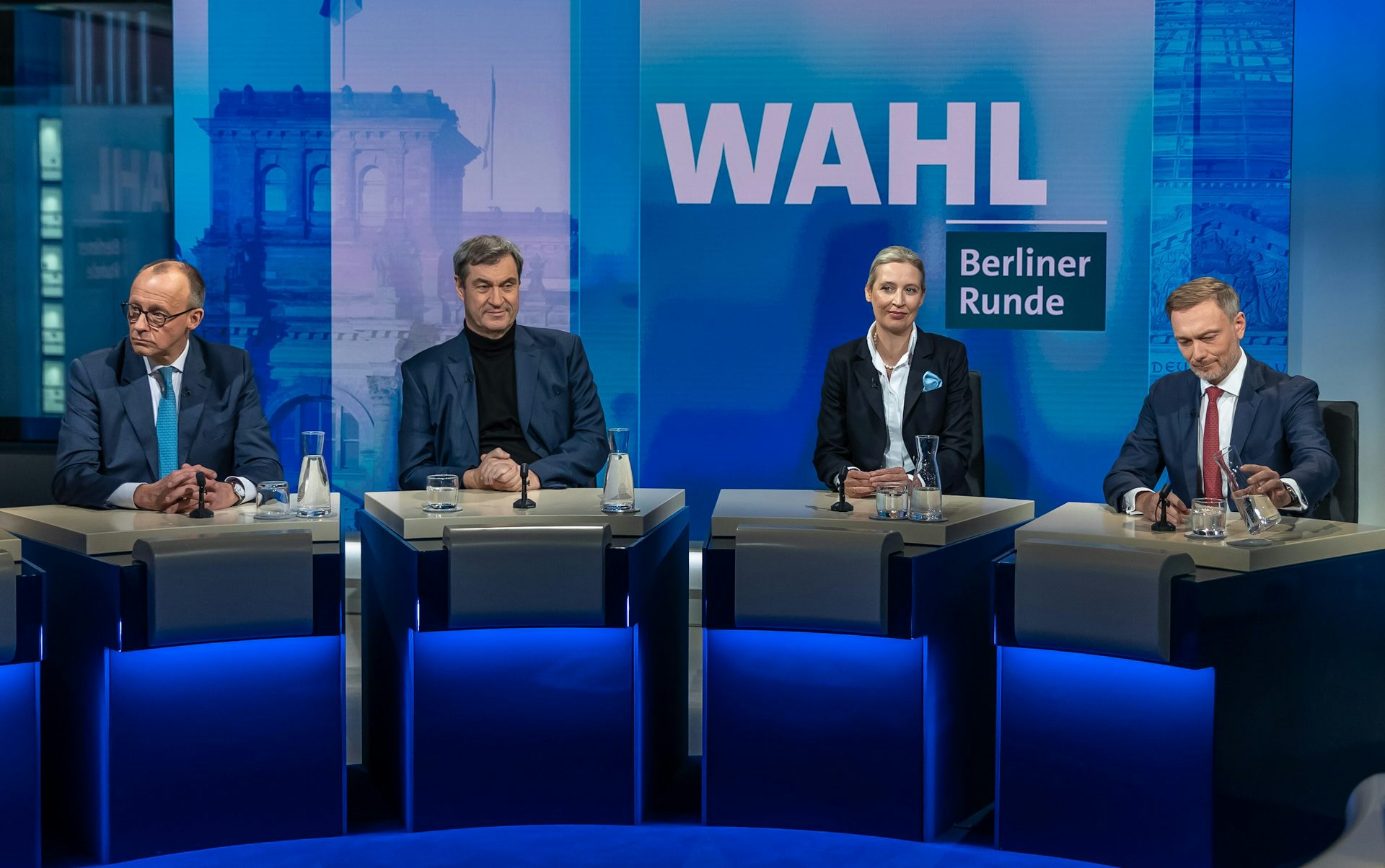 CDU chair Friedrich Merz, CSU chair Markus Soeder, AfD's Alice Weidel and FDP chairman Christian Lindner sit side by side on a TV set