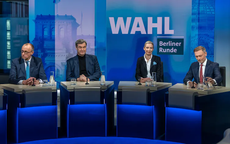 CDU chair Friedrich Merz, CSU chair Markus Soeder, AfD's Alice Weidel and FDP chairman Christian Lindner sit side by side on a TV set