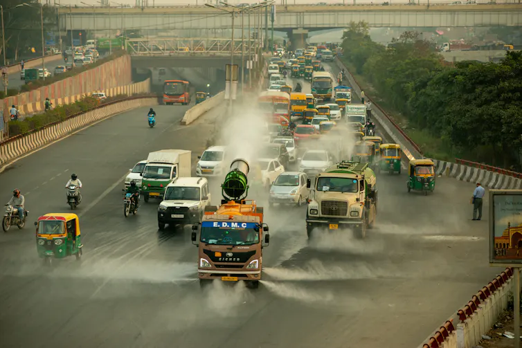 Truck sprays water on busy road