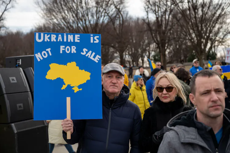 Pro-Ukraine demonstratorsone holding a placard reading 'Ukraine is not for sale'.