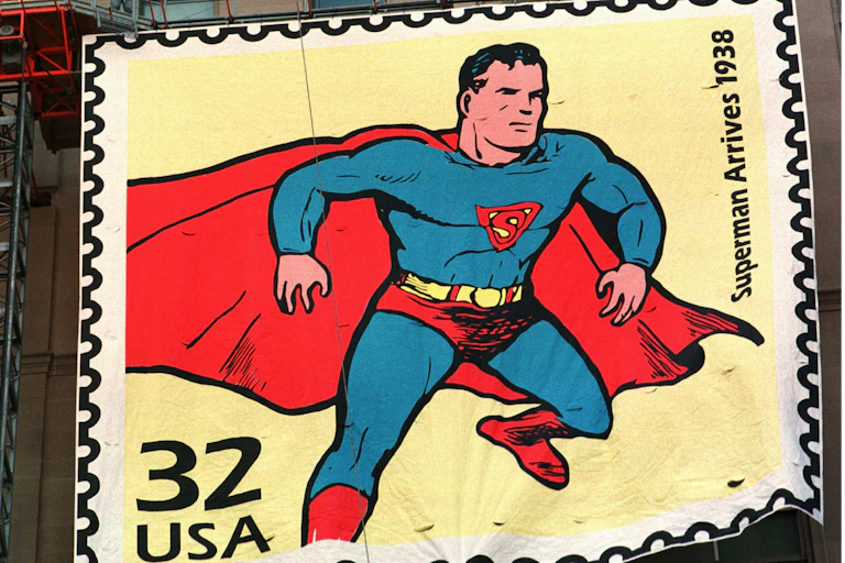 A large sign depicts a man in a tight blue suit and red cape.