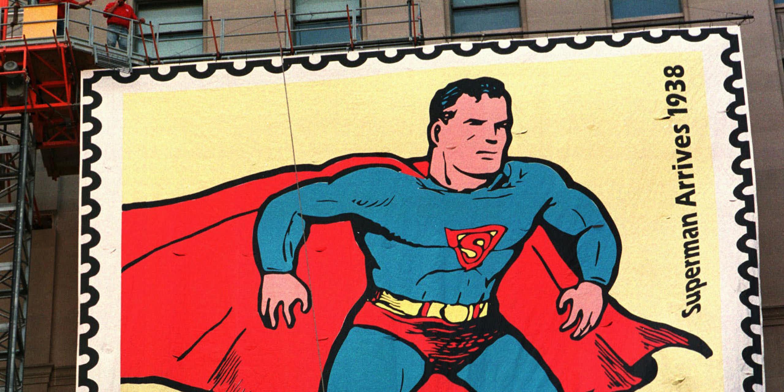 A large sign depicts a man in a tight blue suit and red cape.