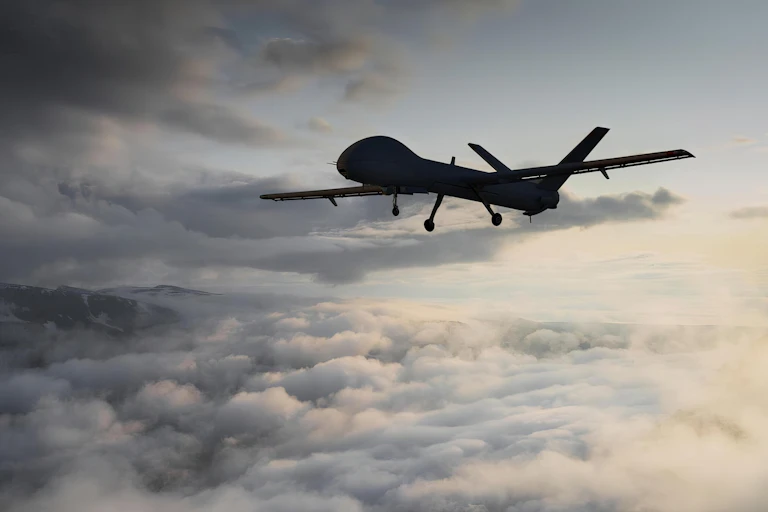 military drone flying through clouds