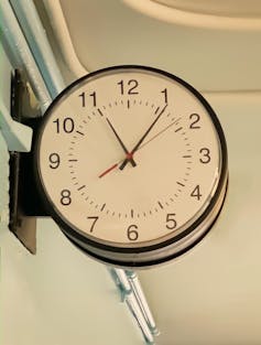 analog clock mounted perpendicular to a wall
