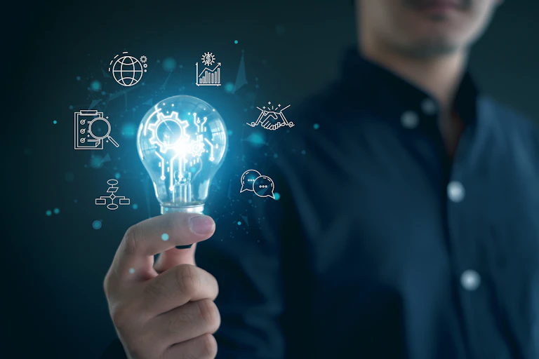 innovation concept, cropped image of man holding a lightbulb with illustrated elements