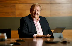 Man sitting behind desk