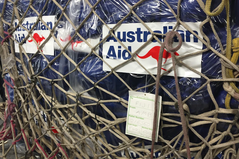 Australian aid supplies behind mesh wiring