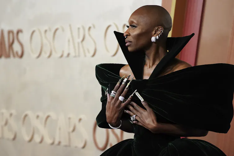 Erivo in a structured dark green gown.