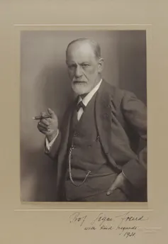A bearded man with a cigar.