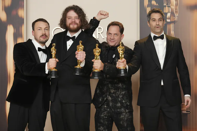 The men with their Oscars.