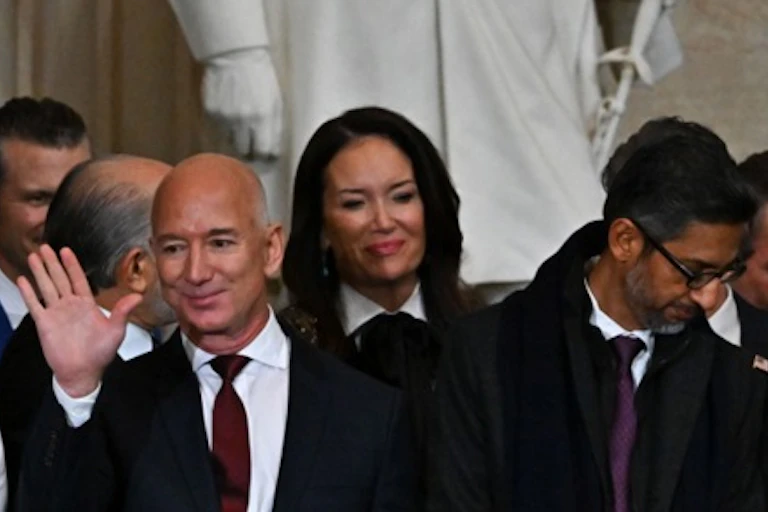 Jeff Bezos waving in front of a statue and in a crowd at the presidential inauguration.