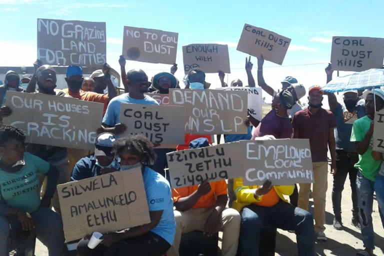About 20 people holding placards that read 'no to coal dust', 'coal dust kills', 'no grazing land for cattle'