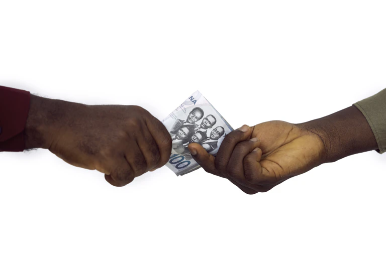 Two hands exchanging money
