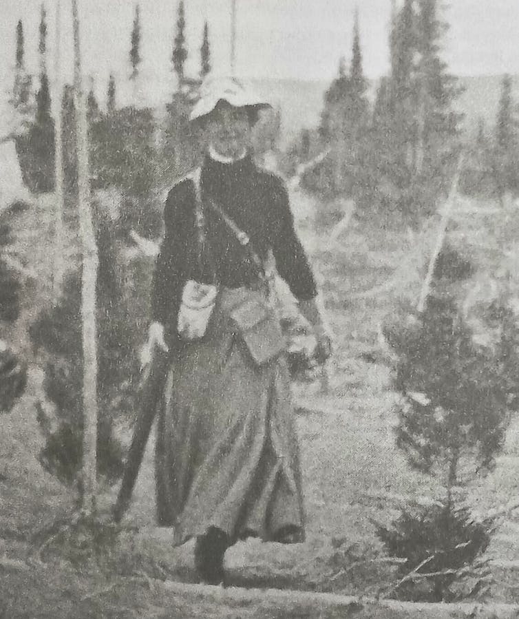 Mina Hubbard black and white photo of woman striding towards camera