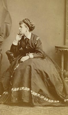 Queer theatre within the nineteenth century was once a spot of codes, cross-dressing and blackmail 1 An actor sat in a chair dressed in a woman's long dress with hair tied back.