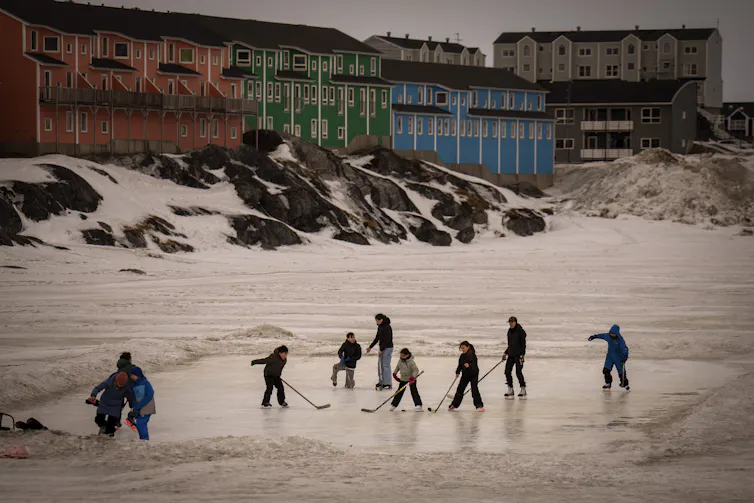 Children play on the ice in Nuuk, Greenland.