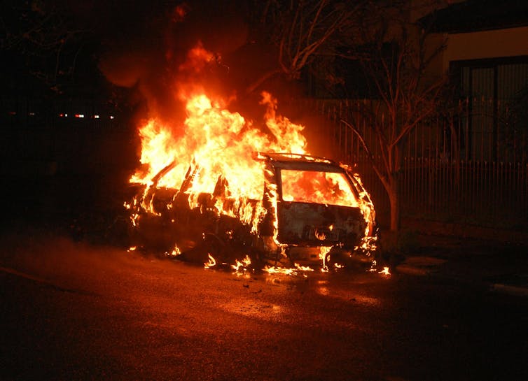 car on fire at night.