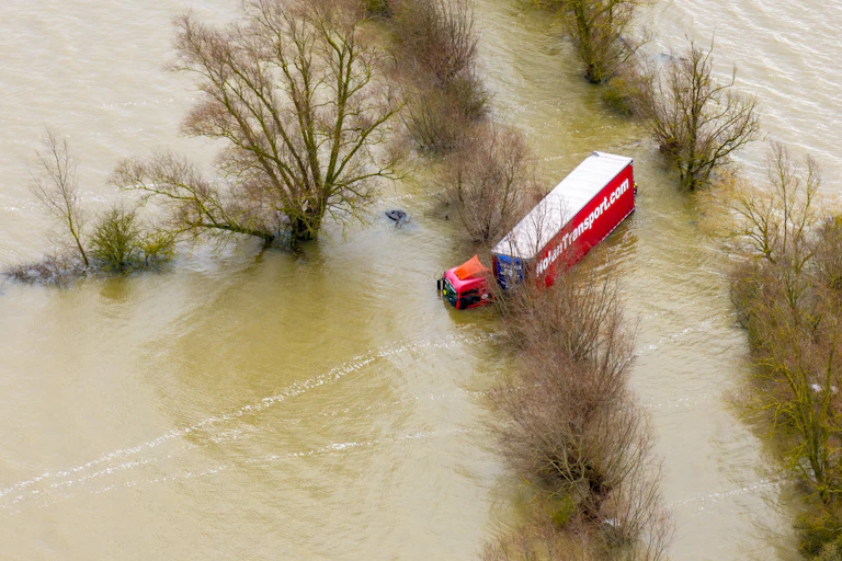 aerial shot of lorry on flooded road