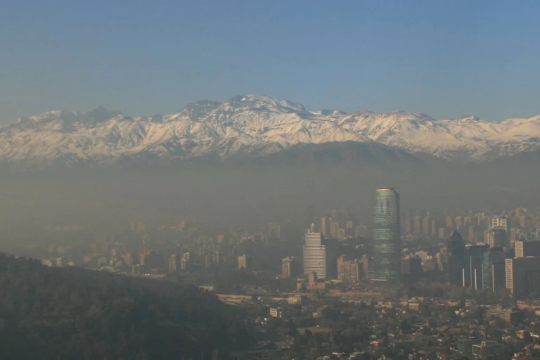 smog over a city with mountains in background