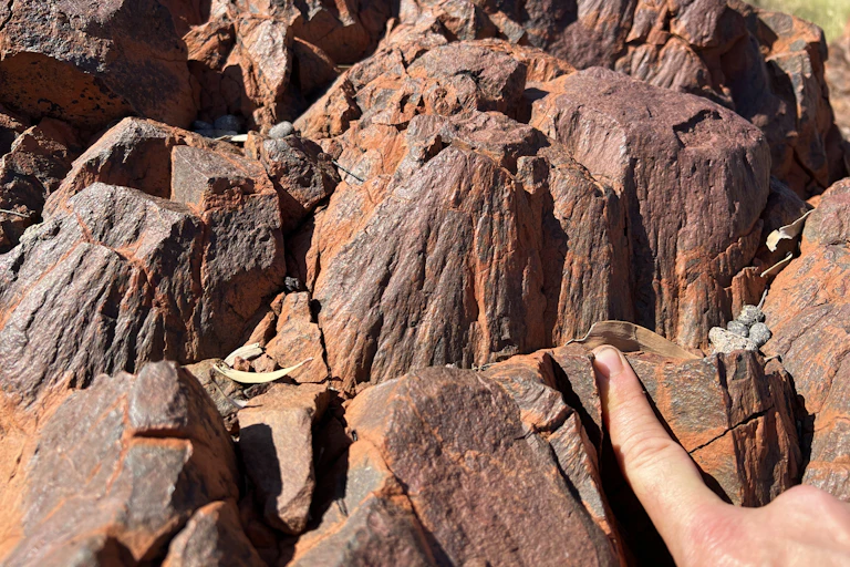 Red cone-shaped rocks close up.