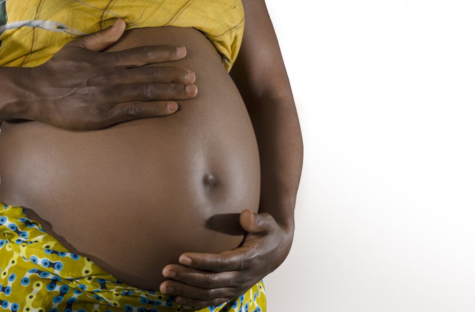 A pregnant woman holding her belly